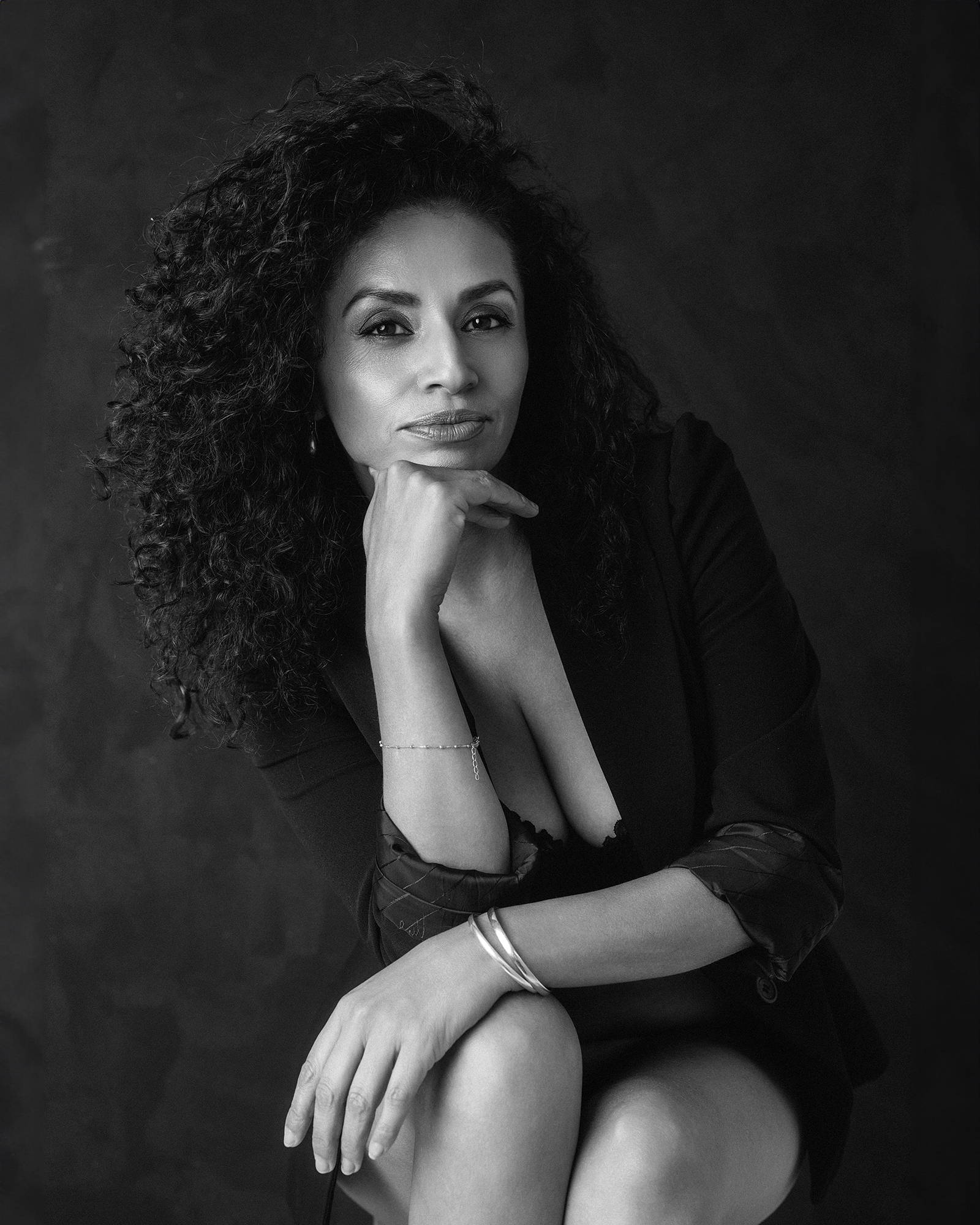 Black and white intimate boudoir photography; portrait of a beautiful woman in studio